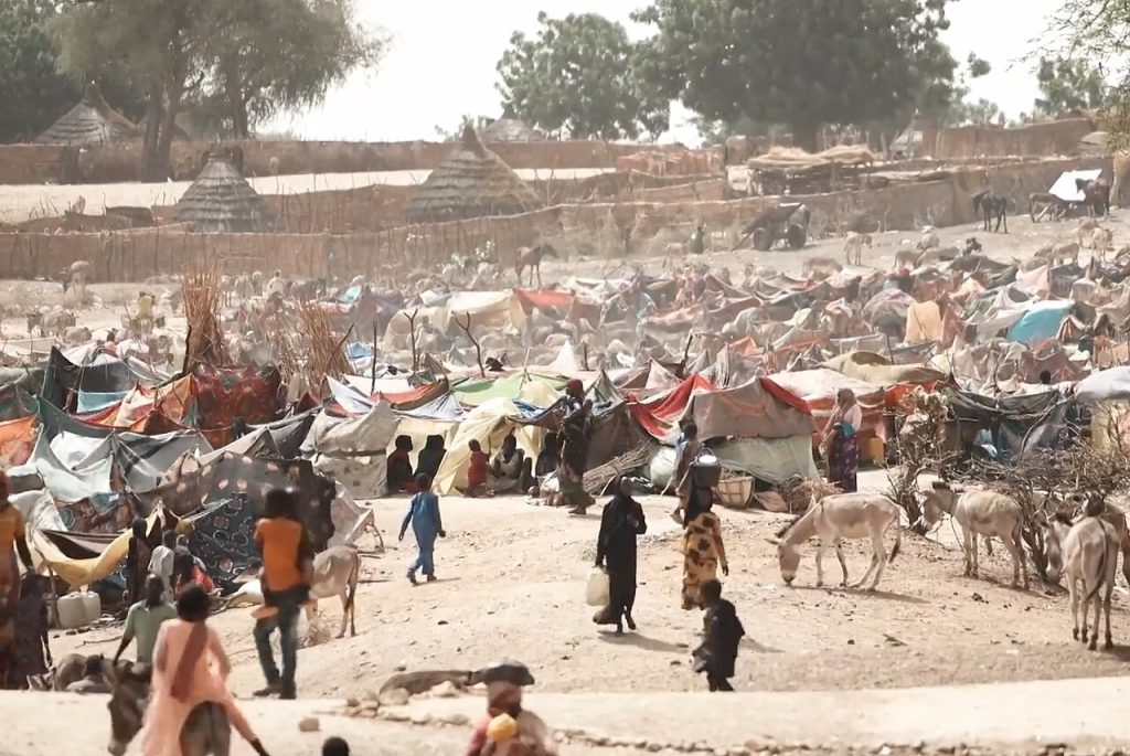 A screengrab from VOA's Number of Refugees Who Fled Sudan for Chad Double in Week. This is a refugee camp in Chad. Photo: Henry Wilkins/VOA/Wikimedia Commons.