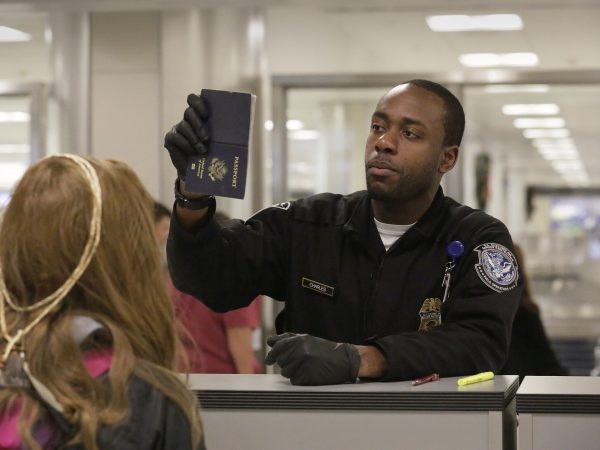 U.S. Customs and Border Protection officers screen international passengers arriving at the Dulles International Airport in Dulles, Va., November 29, 2016. U.S. Customs and Border Protection Photo by Glenn Fawcett on Flickr. United States Government Work.