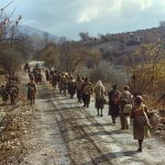 a group of people walking down a road