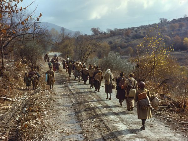 a group of people walking down a road