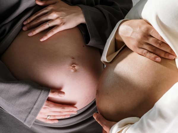 Two Pregnant Women Touching with their Bare Bellies. Photo source: Cottonbro Studio / Pexels, Public Domain.