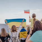 A vibrant demonstration in Szczecin, Poland featuring crowds waving Polish and Ukrainian flags in unity. photo source: Inka Kapturewska / Pexels, Public Domain.