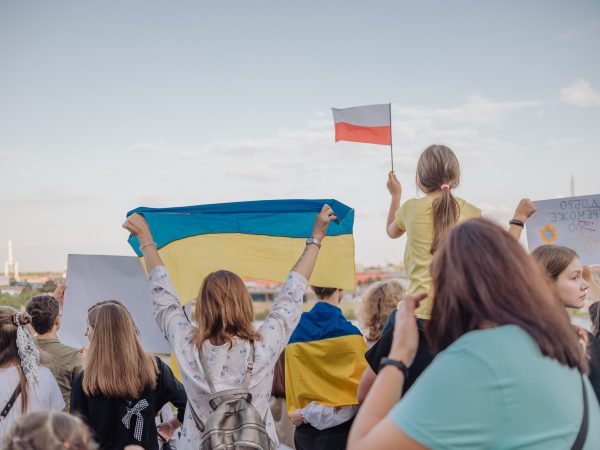 A vibrant demonstration in Szczecin, Poland featuring crowds waving Polish and Ukrainian flags in unity. photo source: Inka Kapturewska / Pexels, Public Domain.