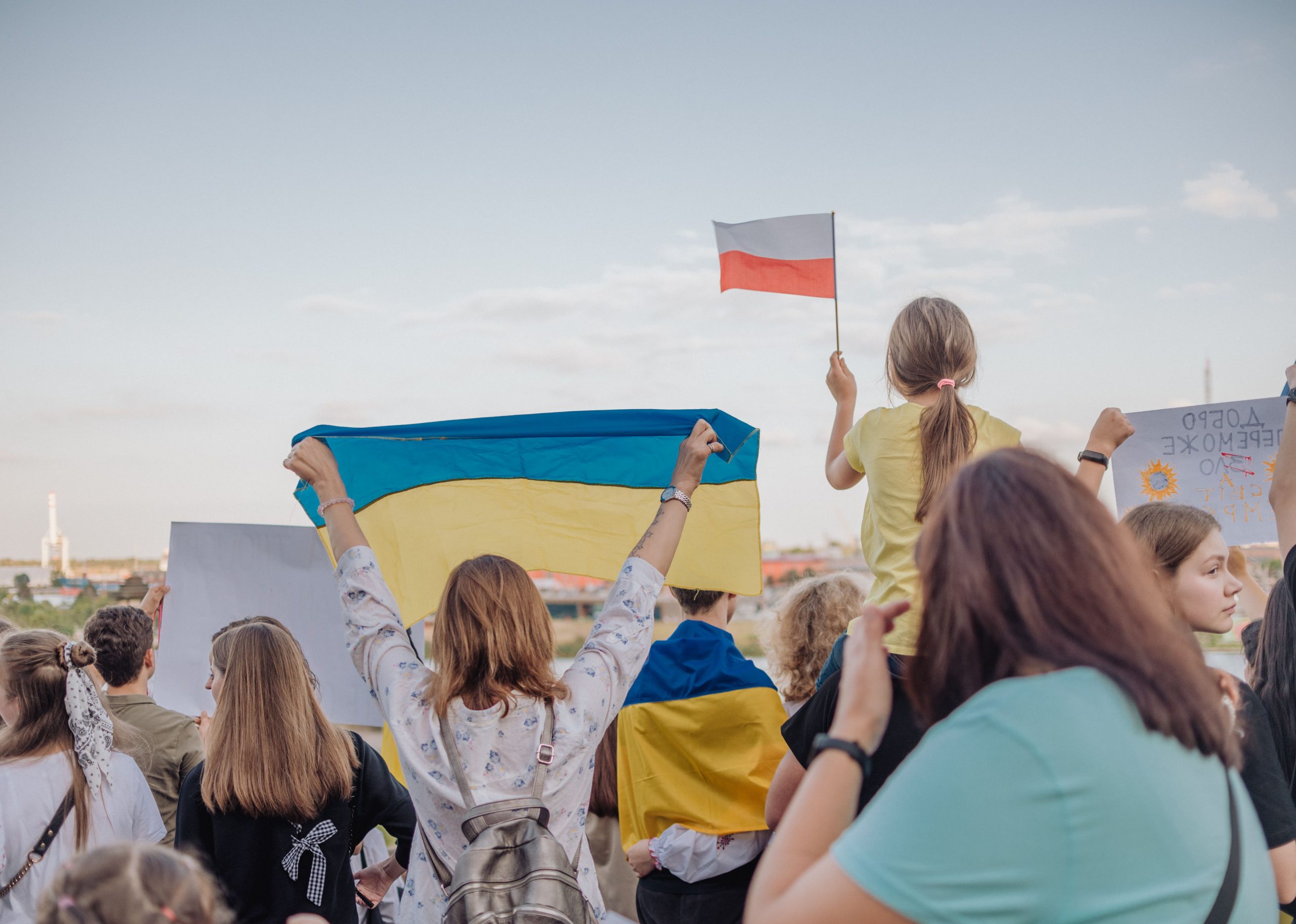 A vibrant demonstration in Szczecin, Poland featuring crowds waving Polish and Ukrainian flags in unity. photo source: Inka Kapturewska / Pexels, Public Domain.