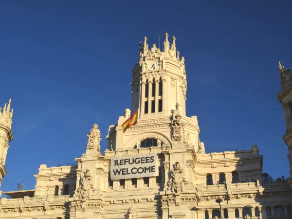 Spanish Parliament Building with Refugees Welcome banner, 2018. Photo source: Katya Belka / Shutterstock.