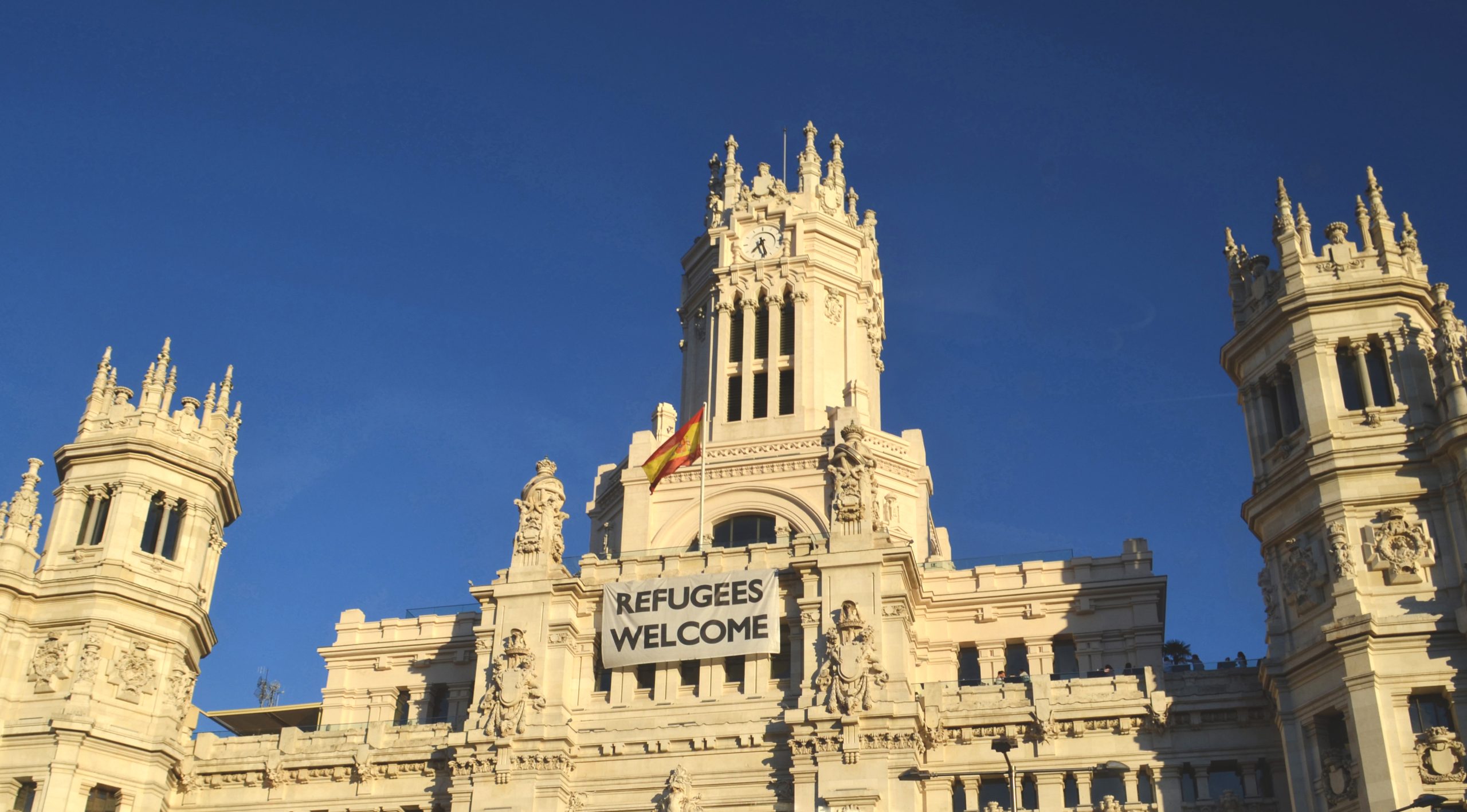 Spanish Parliament Building with Refugees Welcome banner, 2018. Photo source: Katya Belka / Shutterstock.