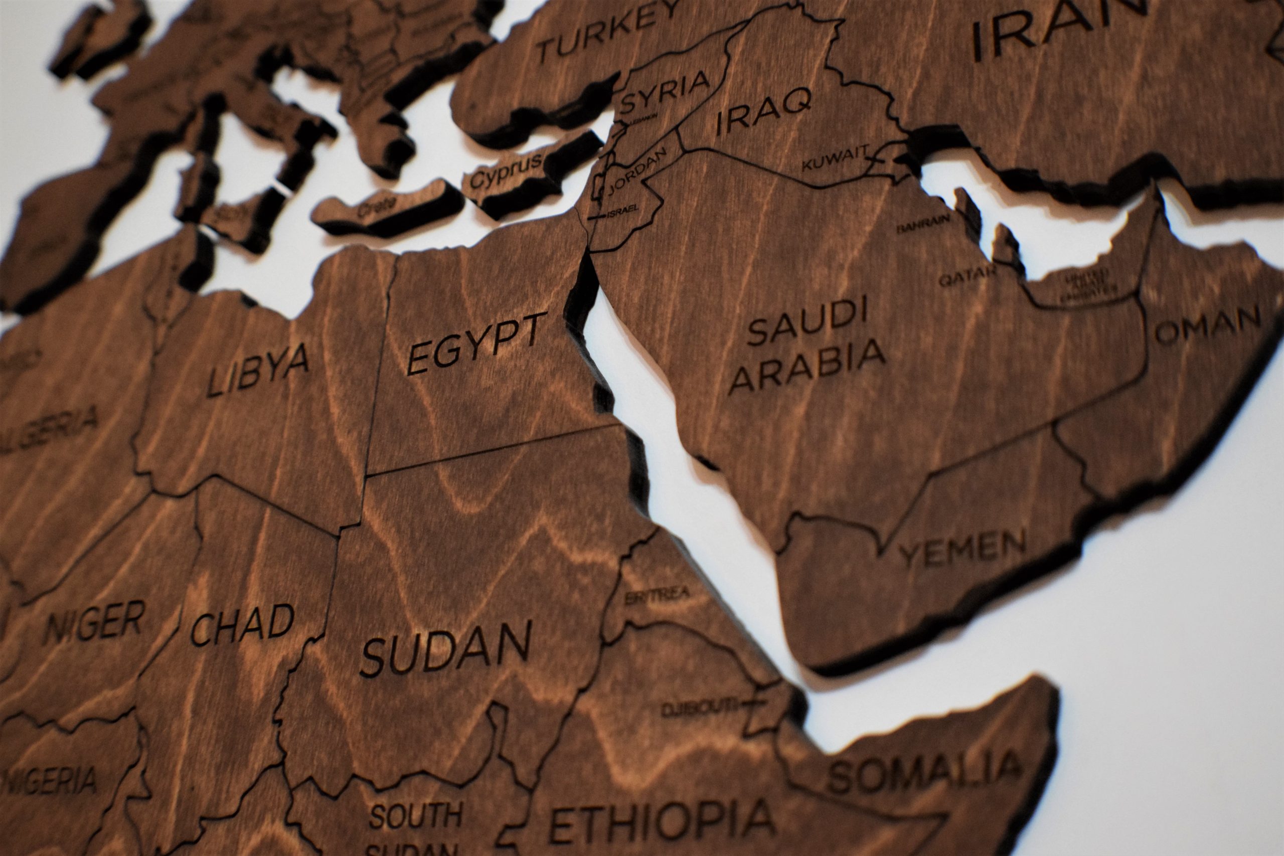 Detailed wooden jigsaw map featuring countries from North Africa and the Middle East. Photo source: Anthony Beck / Pexels.
